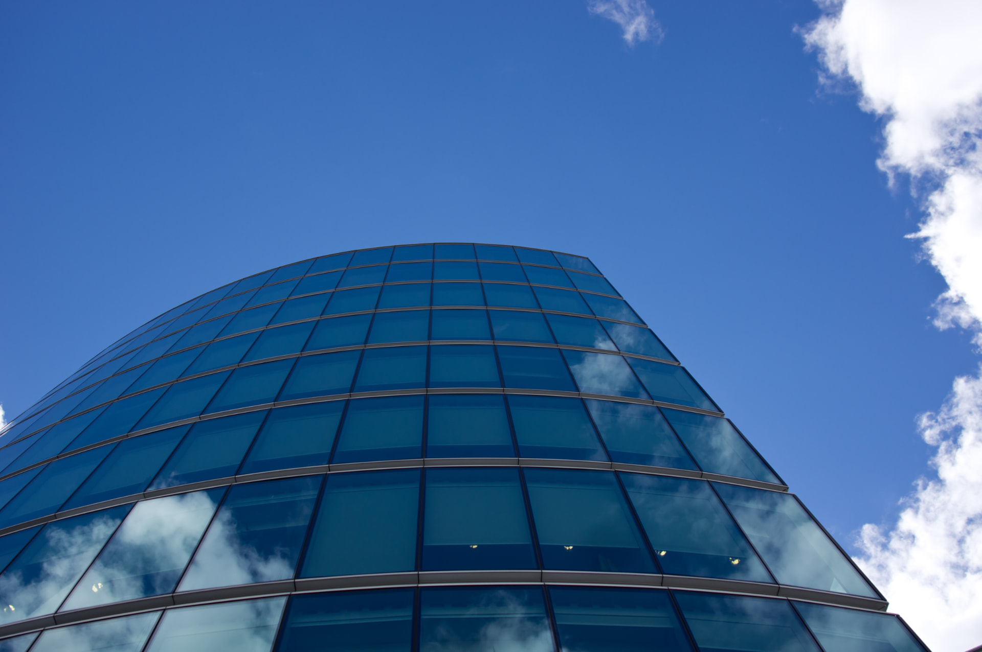 Modern glass office tower reflecting the sky, Rotvogel Zug